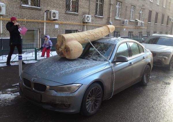 Putin Critic Surprised with 200-Pound Wooden Penis On BMW